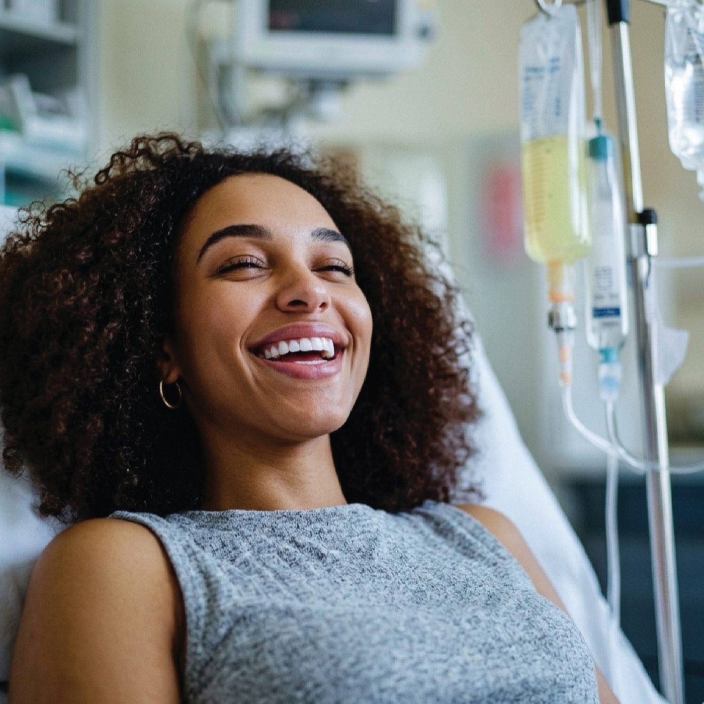 A guest smiling while relaxing during IV hydration